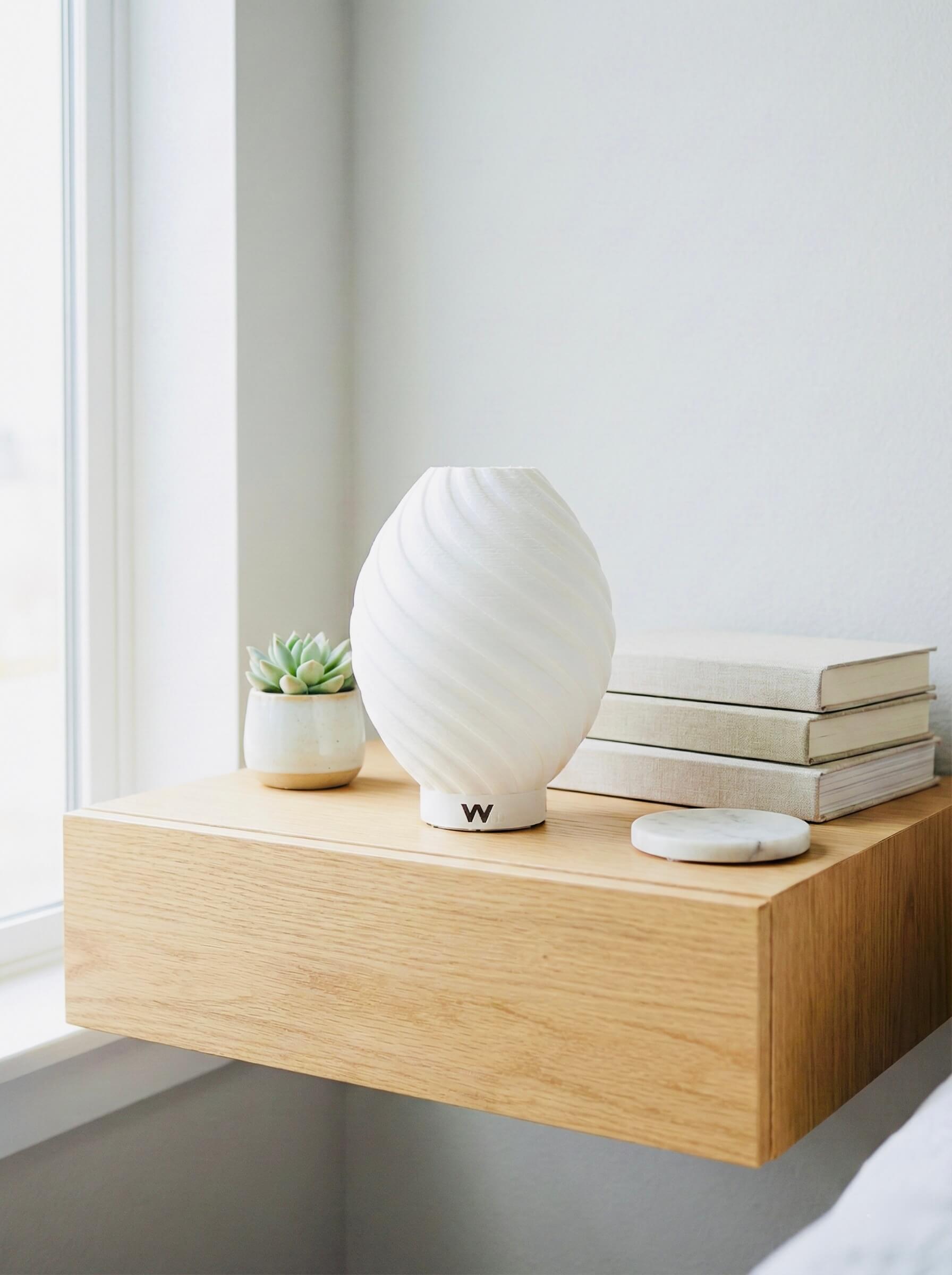 Modern spiral bedside lamp creating a warm, relaxing bedroom atmosphere