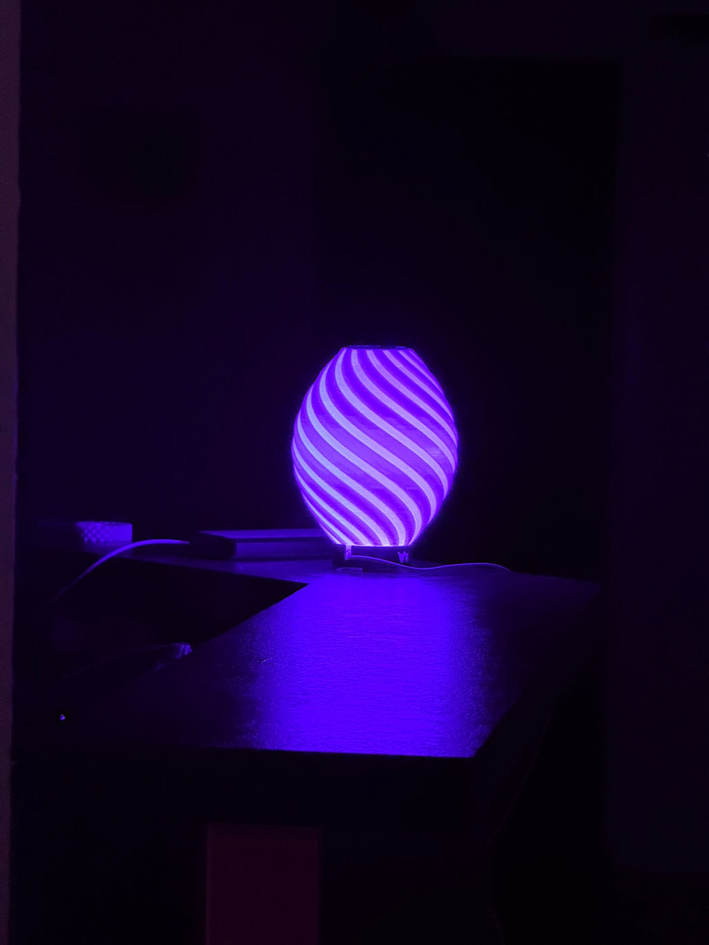 Spiral LED lamp illuminated in purple light for ambient mood lighting